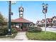 Classic clock tower nestled within a park setting, adorned with holiday decor and seasonal plantings at 301 Cobblestone Trl, Avondale Estates, GA 30002