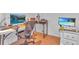 Bright home office with hardwood floors, dual monitors, and ample desk space for productivity at 301 Cobblestone Trl, Avondale Estates, GA 30002