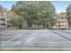 Outdoor tennis court surrounded by mature trees providing natural shade at 301 Cobblestone Trl, Avondale Estates, GA 30002