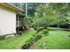 Lush backyard with a creek, grassy area, and a screened-in porch, ideal for outdoor enjoyment at 3272 Pinestream Nw Rd, Atlanta, GA 30327
