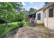 Landscaped backyard with a creek, stone patio, and a screened-in porch providing a tranquil retreat at 3272 Pinestream Nw Rd, Atlanta, GA 30327