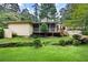 Expansive backyard featuring a creek, lawn, and screened-in porch, perfect for outdoor entertaining at 3272 Pinestream Nw Rd, Atlanta, GA 30327