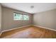 This cozy bedroom has gleaming hardwood floors and dual windows offering views of the surrounding greenery at 3272 Pinestream Nw Rd, Atlanta, GA 30327