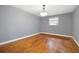 This spacious bedroom features warm hardwood floors, neutral colored walls, and a window for natural light at 3272 Pinestream Nw Rd, Atlanta, GA 30327