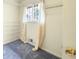 Walk-in closet features carpeted floors, window with curtains and installed shelving for ample storage space at 3272 Pinestream Nw Rd, Atlanta, GA 30327