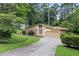 Charming ranch home with stone accents, lush landscaping, and a long driveway at 3272 Pinestream Nw Rd, Atlanta, GA 30327