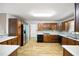 Traditional kitchen with wooden cabinets, stainless steel refrigerator, light countertops and modern backsplash at 3272 Pinestream Nw Rd, Atlanta, GA 30327