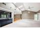 Large living room featuring high ceilings, a wet bar, skylights, and natural light at 3272 Pinestream Nw Rd, Atlanta, GA 30327