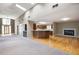 Living room and open kitchen with hardwood flooring, a fireplace, and lots of light at 3272 Pinestream Nw Rd, Atlanta, GA 30327