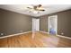 Main bedroom boasts hardwood floors, a ceiling fan, neutral paint, and convenient access to an ensuite bath at 3272 Pinestream Nw Rd, Atlanta, GA 30327