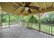 Covered porch with wooden floors, railings, and a ceiling fan offering a relaxing outdoor space at 3272 Pinestream Nw Rd, Atlanta, GA 30327