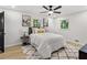Cozy bedroom with a ceiling fan, two windows, a bed and art pieces on the walls at 1239 Teakwood Trl, Stone Mountain, GA 30083