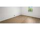 Bedroom features hardwood floors, a window with green views, and white walls at 1239 Teakwood Trl, Stone Mountain, GA 30083