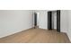 Bedroom with hardwood floors, closet with bifold doors and door leading to hallway at 1239 Teakwood Trl, Stone Mountain, GA 30083