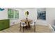 Modern dining area featuring a round wooden table with white chairs, art and large window at 1239 Teakwood Trl, Stone Mountain, GA 30083
