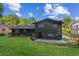 A two-story home with a sleek black brick exterior, complemented by a well-maintained lawn and mature trees at 1239 Teakwood Trl, Stone Mountain, GA 30083