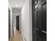 Long hallway features black doors, white walls, and laminate floors at 1239 Teakwood Trl, Stone Mountain, GA 30083