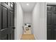 Hallway featuring a neutral color scheme, with black doors, light floors, and white walls at 1239 Teakwood Trl, Stone Mountain, GA 30083