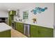 Bright kitchen with white countertops, green cabinets, stainless steel appliances, and a decorative plate display at 1239 Teakwood Trl, Stone Mountain, GA 30083