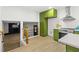 Spacious kitchen with modern stainless-steel appliances and green cabinetry, adjoined by a living area at 1239 Teakwood Trl, Stone Mountain, GA 30083