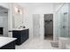 Bright bathroom featuring double vanity, walk-in shower, and white countertop at 203 Holden Way, Woodstock, GA 30189