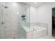 Bathroom featuring marble tiled shower and separate soaking tub at 203 Holden Way, Woodstock, GA 30189