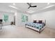 Spacious bedroom with large windows, modern ceiling fan, and adjacent sitting area at 203 Holden Way, Woodstock, GA 30189