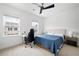 Sunlit bedroom with a desk, featuring two windows and neutral décor at 203 Holden Way, Woodstock, GA 30189
