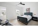 Neutral bedroom featuring a stylish bed, ceiling fan, and sunny windows at 203 Holden Way, Woodstock, GA 30189