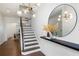 Bright foyer featuring hardwood floors, a staircase, and an elegant light fixture at 203 Holden Way, Woodstock, GA 30189