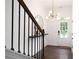Open foyer view with stylish lighting fixture and staircase with decorative newel post at 203 Holden Way, Woodstock, GA 30189