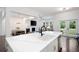 Modern kitchen with a spacious island overlooks the dining area and living room at 203 Holden Way, Woodstock, GA 30189