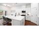 Modern kitchen featuring white cabinets, spacious countertops and stainless steel appliances at 203 Holden Way, Woodstock, GA 30189