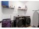 Laundry room featuring washer, dryer, and wire shelving at 203 Holden Way, Woodstock, GA 30189