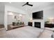 Open living and dining space with a fireplace, large screen TV, and hardwood floors at 203 Holden Way, Woodstock, GA 30189