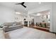 Bright open-concept living room with modern ceiling fan flows into a contemporary kitchen and dining area at 203 Holden Way, Woodstock, GA 30189