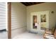 Patio featuring white trim double doors, concrete flooring, and two wooden chairs at 203 Holden Way, Woodstock, GA 30189