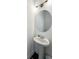 Modern powder room featuring a stylish pedestal sink and contemporary lighting at 203 Holden Way, Woodstock, GA 30189