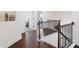 Bright staircase with dark wood floors and decorative vases on the upper landing at 203 Holden Way, Woodstock, GA 30189