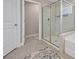 Modern bathroom featuring a glass-enclosed shower, neutral tiling and an open doorway at 2118 Harmony Dr, Canton, GA 30115