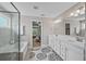 Bright bathroom with double vanity, large mirror and glass shower enclosure offers a spa-like feel at 2118 Harmony Dr, Canton, GA 30115
