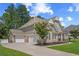 A beautiful two-story home showcasing a three-car garage and a well-maintained lawn and landscaped grounds at 2118 Harmony Dr, Canton, GA 30115