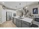Open kitchen with large island, stainless steel appliances, white cabinets, and view into the living room at 2118 Harmony Dr, Canton, GA 30115