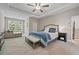 Serene main bedroom with a tray ceiling, sitting area, and a large window, offering a relaxing retreat at 2118 Harmony Dr, Canton, GA 30115