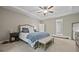 A spacious main bedroom boasts a tray ceiling, carpet floors and ensuite bathroom entrance at 2118 Harmony Dr, Canton, GA 30115