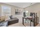 Well-lit home office with modern desk setup, stylish seating, and bright windows at 2118 Harmony Dr, Canton, GA 30115