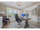 Bright home office featuring large windows, wood floors, neutral paint, and a comfortable workspace at 2118 Harmony Dr, Canton, GA 30115