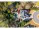 An aerial shot showcases the backyard pool, patio, lush landscaping, and driveway of the property at 2461 Oak Grove Ne Ests, Atlanta, GA 30345