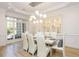 Bright dining room with large windows, modern light fixture, hardwood floors and built-in cabinetry at 2461 Oak Grove Ne Ests, Atlanta, GA 30345