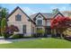A charming two-story brick home with a manicured lawn, mature trees, and a welcoming front entrance at 2461 Oak Grove Ne Ests, Atlanta, GA 30345